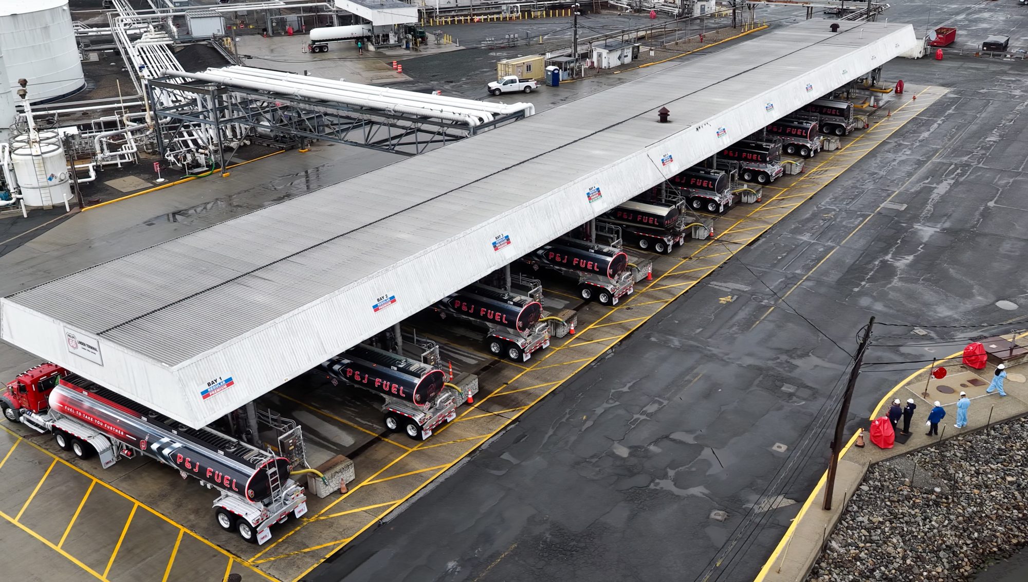 A row of P&J Fuel tankers loading at a terminal rack
