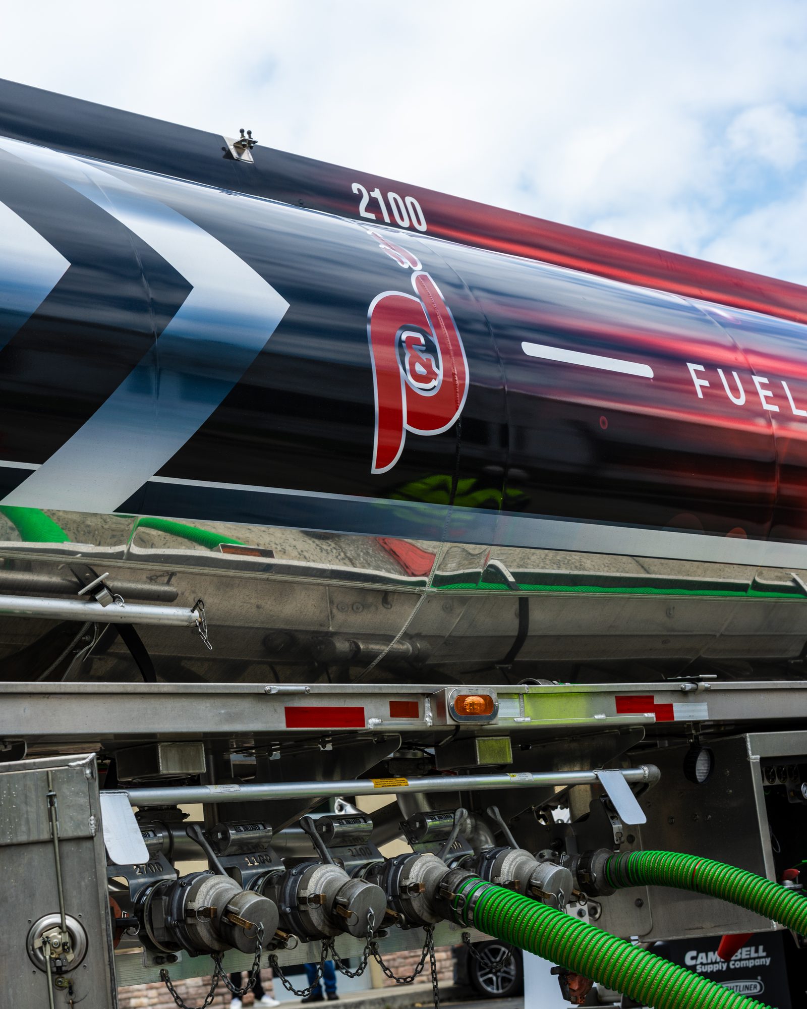 Close view of a P&J Fuel tanker with delivery hoses connected